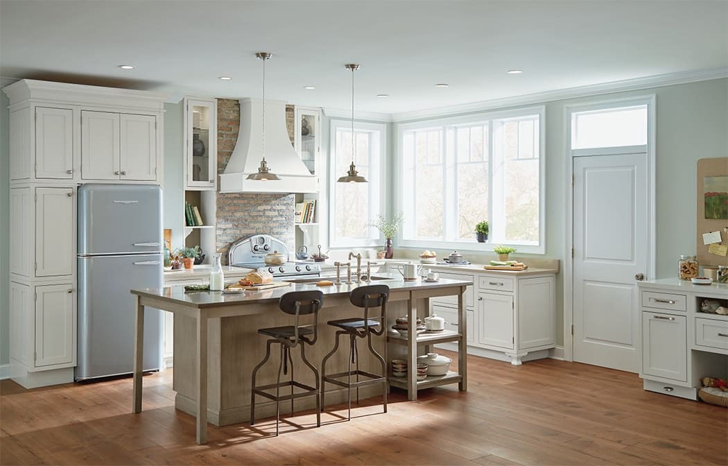 Nicely done kitchen with light colored wood flooring