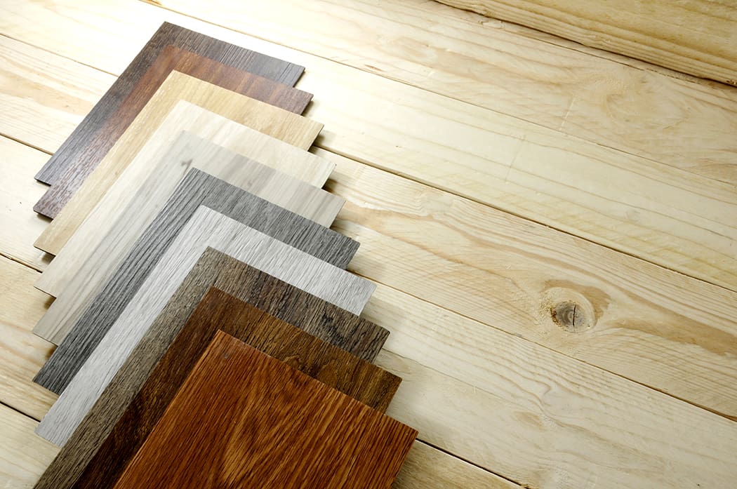 Multiple flooring swatches on a wood floor